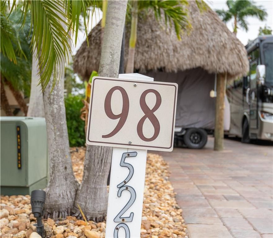 Welcome to Lot 98, a beautifully maintained RV lot offering the perfect blend of tropical outdoor living and functional indoor space.  Surrounded by mature palms and lush landscaping that create a private, resort-style setting.

A standout feature of this property is the large thatched tiki hut, complete with a fully equipped outdoor kitchen—ideal for entertaining family and friends. For sports enthusiasts, the tiki also features two TVs, making it the perfect spot to catch the big game while enjoying the Florida lifestyle.

The lot includes a finished shed designed for versatility, a mini-split A/C system, ceiling fan, and a convenient bathroom with shower—perfect for guests, hobbies, or additional living space.

With thoughtful upgrades and a welcoming coastal vibe, Lot 98 offers a turnkey opportunity to enjoy resort living at its best. Whether you’re seeking a seasonal retreat or a full-time RV lifestyle, this lot is ready for you to pull in and start enjoying everything the community has to offer. RV lifestyle, this lot is ready for you to pull in and start enjoying everything the community has to offer.  Seller has purchased another lot and MOTIVATED.