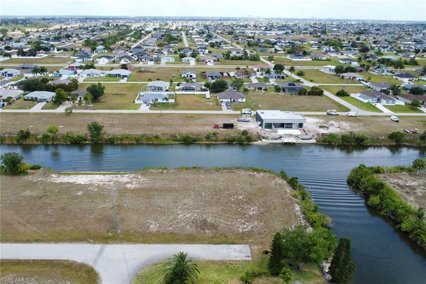 ***RARELY AVAILABLE INTERSECTING CANAL VIEW LOT*** Discover your dream oasis on this pristine single-family lot in sunny Cape Coral, Florida! Nestled along the tranquil freshwater oversized canal on a corner lot boasting intersecting canal views!!! This prime location offers the perfect canvas for your waterfront paradise. Imagine waking up to stunning water views, basking in the Florida sun, and designing your ideal home in this coveted neighborhood. With endless possibilities, this empty lot invites you to create a custom retreat tailored to your desires. Seize the opportunity to build a haven where breathtaking sunsets meet endless outdoor adventures. Don't miss your chance to own a piece of paradise – start envisioning your waterfront escape today!