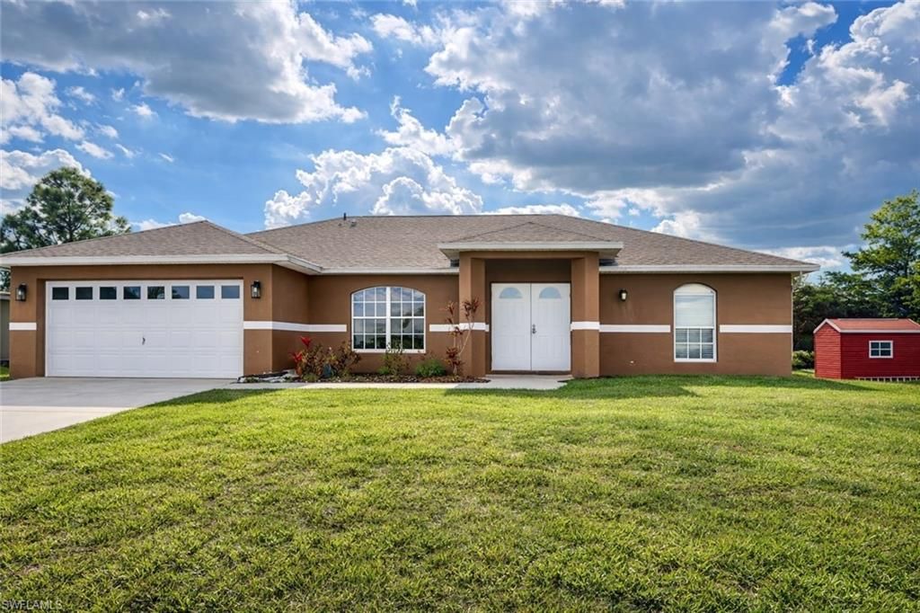 Photo of 528 Peerless CIR, LEHIGH ACRES, FL 33974 (MLS # 225083978)