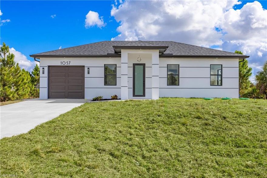 NEW CONSTRUCTION, luxurious contemporary home situated on a large lot, offering extra space, privacy, and great appeal. PRIME LOCATION!! 2 minutes drive to the Mobil Gas Station and 82 RD, making errands quickly and essay. This home is impeccably designed and built with attention to every detail. All lights throughout the home are LED, all doors and windows are high impact and includes a sprinkler system. The open floor plan seamlessly blends indoor & outdoor living. Impeccable white 36x36 porcelain title floors with membrane under tile, which prevents cracks from wear and tear. Expansive living room with high 8" interior and exterior doors. The kitchen boasts gorgeous 42" solid wood soft close cabinets with quartz countertops, a broad counter height island along with stainless steel appliances. This home is approximately 10 minutes' drive to the main shopping centers, restaurants and retail areas, THE BEST SW FLORIDA CAN OFFER