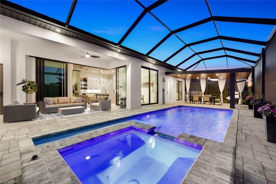 Modern, minimalist and move-in ready.  This Gulf-access pool home in SW Cape Coral checks all the boxes for both high-quality and quality design.   Built in 2023 and sold fully furnished, it offers 2,433 sq ft under air and was designed with a clean aesthetic, thoughtful details, and smart tech that actually makes life easier (not more complicated). Inside, you’ll find wood-look plank tile throughout, 12-ft tall ceilings, 10-ft impact sliders, upgraded lighting, and extra-tall baseboards — all working together to give the home that open, uncluttered feel. The kitchen is a standout: Bosch appliances, custom cabinetry with panel-matched fridge and dishwasher, pot filler, wine fridge, soft-close drawers, and a big walk-in pantry. It opens right up to the dining area, great room, and lanai so everything flows — perfect for entertaining or just keeping an eye on your favorite game while you cook and entertain. The split floor plan includes a spacious primary suite with sliders to the lanai, two custom walk-in closets, and a bathroom that feels like a spa — double vanities, a soaking tub, and a big walk-in shower with multiple heads. Three additional large bedrooms, one features an ensuite bathroom, and another is currently set up as a dedicated home office, complete with upgraded modern iron/glass door, custom shelving, and lighting — ideal for remote work or creative space. The lanai is fully pavered and ready for real Florida living — saltwater pool with sun shelf and lighting package, outdoor shower, summer kitchen, and two covered lounge areas. There’s even room to hang out in those swinging chairs (you’ll see in the pics). The 3-car garage is climate-controlled and loaded with extras — a Tesla charger, TV, stereo speakers, storage cabinets, large fan, and utility sink. Currently, part of the space is set up with professional-grade gym equipment and a professional climbing wall (can stay or go, up to the buyer). Smart features include Nest thermostat, custom lighting, and many outlets are wired with USB/Bluetooth.  So yes, you can plug in just about anything, anywhere. Gulf access means you’re just a quick boat ride from open water. And the location? It’s one of the most sought-after pockets in Cape Coral — close to Cape Harbour, Tarpon Point, shops, restaurants, and even pickleball. Whether you’re looking for a full-time home, a snowbird spot, or a high-performing vacation rental, this one’s worth a look!