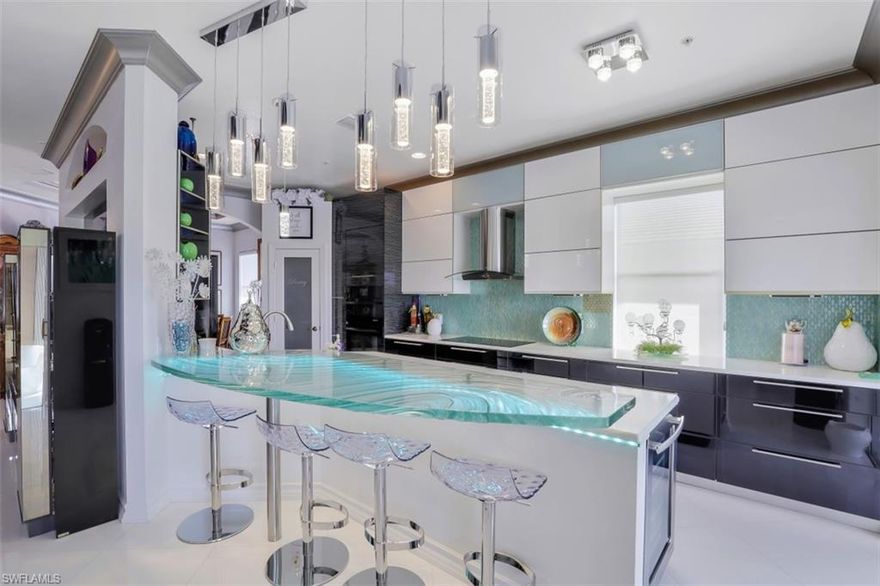 ELEGANT MODERN CUSTOM DESIGN 2nd floor Coach Home Fully renovated from top to bottom with every detail in mind. Features 3 bedrooms and study or 4th bedroom, 2.5 baths. The European expanded kitchen with High Gloss White & Black Onyx & Silver Stripe cabinets. Royal Blanc Quartz countertops, illuminated 1000lb Glass bar (Commission by Artist Jeff Downing). Jenn-Air  Appliances package includes Induction Cook Top, Wall/Microwave Oven and Wine Cooler. Dining Room features a glass bar with lack Onyx countertop and open glass etagere. Miami White Diagonal tile floors throughout including lanai. The Master Suite offers free standing whirlpool bathtub, Euro-Design bath vanities, custom closet cabinets. High end lights/fans New AC & Hot Water Heater, custom special glaze paints. Accordion hurricane shutters. This home is a “must see” to appreciate the finishing touches. The Quarry offers boating, water sports, tennis, pickle ball, bocce. Fitness center, pool resort. Restaurant, Tiki Bar. 18 hole PGA golf and Lodge with private clubhouse & Restaurant.