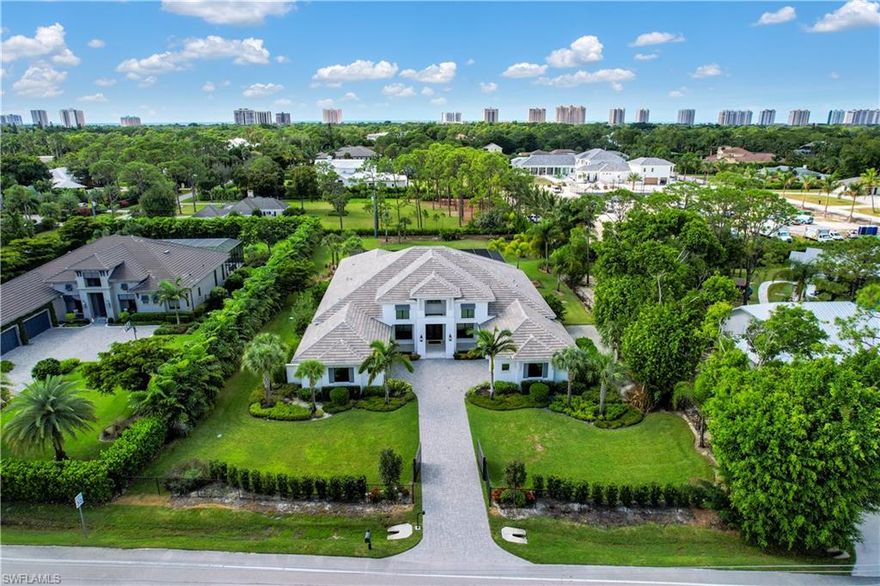 Custom Estate Home just minutes from the Gulf! Luxury features throughout- volume/tray/coffer ceilings, high-end flooring/light fixtures/fans, all impact resistant doors/windows, private gate at front entry, stunning outdoor living space (w/ picture window screening, custom pool & spa, covered lounge area that offers a tv & fireplace, gas fire pit, summer kitchen, and massive under truss sitting area), surround sound system, gourmet kitchen design, & more! Fantastic location in Naples w/ easy access to I-75, short drive to the beaches that line the Gulf Of Mexico, less than 2 miles from the amazing shopping & dining at MERCATO, and only 15 minutes from the world-famous 5th Ave Naples.
