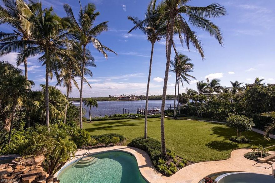 This extraordinarily deep Port Royal estate property allows privacy and a dramatic approach from its access along Nelson’s Walk and permits strategic long water views over verdant rear lawns to Naples Bay. Wrapped in this remarkable setting, the comfortable residence consists of 6 bedroom suites, two offices, a game room, and a highly sought after 5 car garage. Experience the exciting water views and the serenity that a property of this size encourages. Port Royal Club membership eligibility.