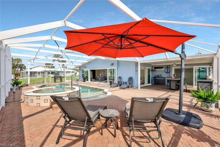 Great Gulf Access Deal!  Motivated Seller!!! Gulf Access Paradise – Renovated 2 Bed, 2 Bath Pool Home with Private Ramp & Dock-----All work PERMITTED BY LEE COUNTY 
Welcome to your Florida waterfront dream! This beautifully renovated 2-bedroom, 2-bath Gulf access pool home offers the perfect blend of luxury, functionality, and low-maintenance living. Situated on a navigable canal, this home is boat lift ready and includes a private boat ramp and a 50-foot composite dock—perfect for any boating enthusiast.
Step inside and enjoy the bright, open living spaces enhanced by new impact-resistant windows and doors, plantation shutters, and remote-controlled privacy blinds. The updated kitchen features granite countertops and overlooks the pool area, making entertaining a breeze.
Outdoors, relax in your 30,000-gallon saltwater pool with a tanning shelf and integrated spa, surrounded by low-maintenance landscaping and a circular paver driveway that adds charm and convenience.
Additional features include:
Exterior & Outdoor Features
• New impact-resistant windows and doors
• Roof replaced in 2023
• HVAC system 2023
• Low-maintenance landscaping
• Circular paver driveway
• Pool pavers 
• 30,000-gallon saltwater pool with tanning shelf
• Pool pump replaced in 2024
• RV hookup (30/50 amp)
• Gravel parking ideal for boat, RV, or other towable toys
• 500-gallon liquid propane (LP) tank
Waterfront & Boating Upgrades
• Private boat ramp (installed 2024)
• Boat lift ready
• 50-foot composite dock with new plumbing and electrical (2024)
• Helicon seawall stabilization repair completed
Interior Upgrades & Technology
• Granite countertops
• Plantation shutters throughout
• Remote-controlled, battery-powered privacy blinds
• Walk-in closets in both bedrooms
• Automatic moisture-sensing bath fan
• TV-ready feature wall with coaxial connection
• Google Nest smart system

Special Notes
• The primary bedroom closet floor shows signs of a previous wall removal which was an old safe room