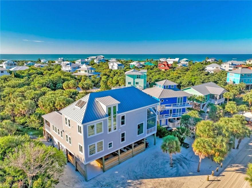 A Legacy Island Estate Designed for La Buena Vida ("the good life"). 
Some homes impress, and then some homes change your rhythm. Villas in the Air is a spectacular luxury estate created for effortless island living, unforgettable gatherings, and moments that linger long after the sun slips below the horizon. Set on North Captiva Island, this expansive retreat offers a rare balance of scale, privacy, and resort-style amenities—where life slows down and every day feels intentional.
From sunrise to sunset, the home unfolds in layers of connection and calm. Mornings begin on the screened terrace with coffee and the sound of distant waves. Afternoons drift by poolside, floating beneath blue skies or gathering at the outdoor bar as laughter carries on the breeze. Evenings rise to the rooftop porch, where a panorama of island views stretches endlessly with sunsets and stars that feel like a private performance just for you.
Designed for both togetherness and retreat, the home offers multiple indoor and outdoor living spaces that allow everyone to spread out - yet always reconnect. The main living level stuns with soaring double-story ceilings and an open-concept great room, wrapped in refined contemporary coastal finishes. A restaurant-inspired kitchen anchors the space, connected to multiple dining areas that flow seamlessly indoors and out.
Accommodations are generous and thoughtfully planned, offering five distinct sleeping retreats. The primary suite feels like a private sanctuary, complete with a spa-style bath and walk-in rain shower. Two additional king guest rooms share a beautifully appointed bath, while a detached poolside guest suite offers privacy and independence with its own en-suite bath. The third-floor retreat, featuring two queen beds and access to a spacious loft lounge, provides flexibility for guests, media space, or a relaxed sleeping haven.
Outdoor living here is nothing short of exceptional. A heated pool, an expansive outdoor bar with TV, a rooftop terrace with panoramic water and preserve views, a grilling area, a wellness space, and multiple entertainment zones transform the property into a true private resort—designed for both quiet escapes and unforgettable celebrations.  Built to later codes with lasting materials like Hardie board siding, impact-resistant windows, a metal roof, composite decking, and aluminum railings.
Located on North Captiva Island, a boat-access-only barrier island celebrated for its pristine beaches, shelling, fishing, birdlife, and miles of preserve trails, this estate offers a lifestyle that can't be replicated on the mainland. Villas in the Air is a legacy-quality island estate that is difficult to replicate - ideal as a private family retreat, a high-end luxury rental, or both. This is much more than just your average island home. It's a place where memories are made, traditions begin, and time finally slows down.