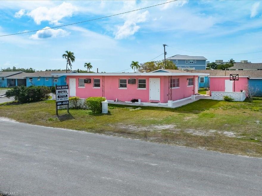 The PINK HOUSE MOTEL ~ Charming old Florida style motel that offers DIRECT GULF ACCESS. This unique opportunity awaits. Make a living in the hospitality business, own a 4 room building on commercial property and run your own business. Each room offers a small kitchenette and bathroom. Located in the historic fishing village of Goodland a golf cart community that offers convenience of golf carting to the popular Stan’s idle hour, Little bar, Paradise found and Crabby lady restaurants, Kirk’s fish house, two private marinas, public boat launch, Margood museum, a playground, park and post office. Goodland is a VOLUNTARY civic association NO HOA FEES or CDD FEES!!!