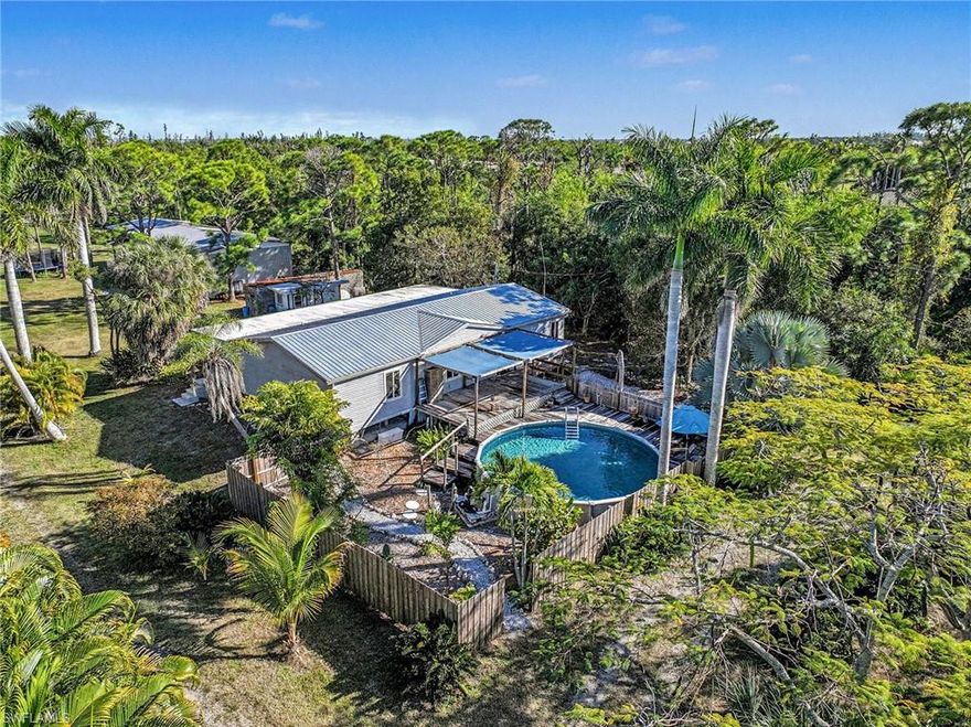 AG-2 Zoned Island Agricultural Homestead- Island meets Homesteading.
Welcome to a rare opportunity to own a true island agricultural homestead in Saint James City. Situated on nearly 5.5 acres of mostly cleared land, this AG-2 zoned property offers the scale, infrastructure, and existing agricultural exemption that are increasingly difficult to find. With public water, a private well, and a functional irrigation system already in place, the groundwork is set for continued or expanded agricultural use, including tree farming, nursery operations, gardening, orchards, or diversified agricultural production.
The land is well configured with open acreage, established access paths, multiple walking and riding trails, and a balance of cleared areas and natural brush that supports productivity, privacy, and future expansion. A gated entry provides controlled access, while the property’s size and layout enable efficient equipment movement, defined planting zones, and operational flexibility. AG-2 zoning allows a wide range of agricultural and rural uses, including crop cultivation, plant and tree nurseries, horticulture, limited livestock, agricultural structures, and a single-family residence associated with agricultural operations (buyer to verify permitted uses).
The 3-bedroom, 2-bath residence offers approximately 1,600 square feet of practical living space well-suited for an owner-operator or full-time homesteading lifestyle. Recent improvements include a brand-new HVAC system, impact-rated windows and front door, and low-maintenance LVP flooring throughout. The open kitchen features granite countertops, stainless steel appliances, a custom stainless steel hood, a double pantry, and ample workspace that connects seamlessly to the main living area.
Additional features include updated bathrooms, an oversized laundry/utility room adaptable for storage, work, or homestead tasks, and a full-length enclosed porch overlooking the property. Outdoor amenities include an above-ground pool and a covered wood deck for relaxation after a day’s work. Supporting structures include a large detached garage/barn with dual sliding doors, ample storage for equipment and supplies, a small shop with a wall unit,  and a cleared turnaround drive for easy access.
Properties of this size, with the zoning and functionality, especially with an agricultural exemption already established, are exceptionally rare, where the island lifestyle is also so easily obtained. Fishing and boating are just moments away when you need a quick break from homesteading or if you want to fill the freezer with fish.   Whether your vision is a working farm, nursery-ready acreage, or a self-sustaining island homestead, 5228 Stringfellow Road offers a unique combination of land, freedom, and long-term value on Pine Island.