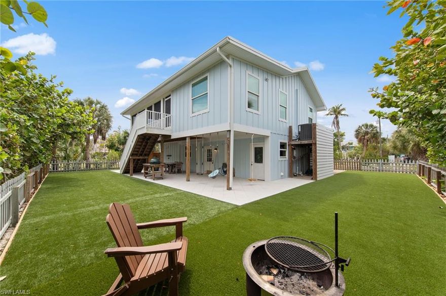 This exceptional Old Florida–inspired residence has been masterfully updated and expanded, with a comprehensive renovation completed in 2022. Thoughtfully designed with both elegance and durability in mind, the home features a standing seam metal roof, Hardie board siding, and impact-rated windows and doors. Timeless coastal architecture meets refined island living, creating an inviting yet sophisticated retreat. The interiors are filled with natural light and showcase elevated, thoughtfully curated finishes throughout—from warm wood flooring to a stunning, private primary suite designed for comfort and tranquility. A gracious front porch welcomes you into a sun-drenched, window-lined sitting area that transitions effortlessly into the main living space. The open-concept design flows seamlessly into a beautifully appointed kitchen, where quartz countertops, custom shaker-style cabinetry, and stainless steel appliances create a clean, elegant focal point. The great room extends to a serene screened outdoor living area, offering the perfect setting for relaxed coastal entertaining. The fully enclosed lower level provides both practicality and versatility, featuring a one-car garage, an expansive storage area, and a dedicated workspace—ideal for hobbies, projects, or additional storage needs.