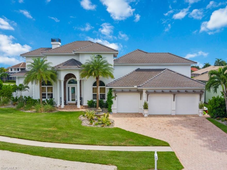 Strikingly grand & beautifully appointed 4 bedroom, 5 bath coastal chic residence with wide canal panoramic water views & western sunset views over a skyline of condo buildings. This home offers fast access to the Gulf of Mexico by boat! This light & bright coastal home boasts two master suites, one on the main level, & one on its own private level, plus two additional spacious guest suites with an abundance of storage and private full bathrooms. Two custom vapor fireplaces, high-end gourmet kitchen with commercial gas stove, double oven, and Sub-Zero freezer & refrigerator, custom elevator to 3 floors, wet bar, office with built-ins, remote & shutter blinds, multi-telescoping sliders & volume ceilings, generator, 3 zone AC, built-in closets. Main master bedroom showcases designer hardwood flooring, shiplap, updated master bath, full gym & workout room, & large private balcony with excellent 360 views, sunrises & sunsets. Multilevel lanai with stone details, resort-style pool, hot tub, wide canal views with converging waterways, highly desired southern exposure. Large dock, 2 lifts. Expertly maintained with a newer roof, 2 artistic eyebrow windows, new seawall cap & more!