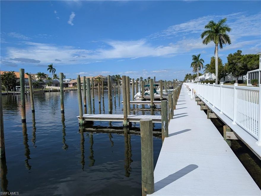 ITS THE OFFER YOU CAN'T REFUSE!!!   Imagine settling into your Fort Myers Beach area seasonal retreat! This renovated, two-story waterfront townhouse at Boardwalk Caper is the ultimate BOATER'S DREAM for those relocating or seeking a vacation lifestyle. The DEEDED DOCK (#110) and deep-water access mean you are just minutes from the Gulf—perfect for fishing, cruising, and Southwest Florida exploration. Move-In Ready Perfection for Buyers. This property is 100% ready for you to enjoy, ideal for snowbirds or second-home owners who want zero maintenance hassles upon arrival. Every system has been addressed: new flooring, electrical, plumbing, high-end cabinetry, and stainless steel appliances. Enjoy the peace of mind provided by impact-resistant, double-pane windows in key areas, essential for coastal protection. Flexible & Comfortable Layout. Two spacious bedrooms, each with a private en-suite bathroom—offering luxury and privacy for you and your guests. The flexible guest area is perfect for a seasonal office or hobby space, featuring a Murphy bed and custom built-ins. Prime Coastal Location. Located within a vibrant boating community close to the action of Fort Myers Beach. Plus, enjoy the convenience of assigned parking directly next to the courtyard entrance. Don't miss this rare chance to own a fully updated waterfront property with dock access in a premier Southwest Florida location. Schedule your private viewing today and secure your permanent spot on the water!