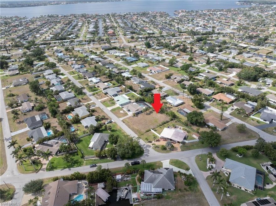 There’s something special about finding a homesite in a neighborhood that already feels like home—and this one captures that feeling beautifully.

Set in the heart of Cape Coral’s iconic Yacht Club area, this property offers a rare chance to build in one of the city’s most established and beloved coastal communities. This is where Old Florida charm meets a renewed vision for the future, creating a setting that feels both timeless and full of possibility.

Just moments away, the Cape Coral Yacht Club is undergoing a truly transformative, large-scale redevelopment—an investment that is reshaping the entire area. Plans include a reimagined beachfront, upgraded marina, enhanced dining experiences, expanded recreational spaces, and thoughtfully designed gathering areas that will bring new life and energy to this already cherished destination. It’s the kind of revitalization that not only elevates your lifestyle, but also strengthens long-term value in the surrounding neighborhood.
Life here naturally invites you outdoors. Imagine starting your mornings with a bike ride to the beach or an evening stroll as the sun sets along the Caloosahatchee. With the Yacht Club’s exciting evolution underway, the experience of living here will only continue to grow richer and more vibrant.
Just beyond your doorstep, downtown Cape Coral adds another layer of convenience and charm. Local dining, boutique shopping, and entertainment are all within easy reach, creating a lifestyle that feels both connected and relaxed.

Surrounded by mature homes, tree-lined streets, and a genuine sense of community, this homesite offers more than just a place to build—it offers a foundation for the way you want to live. Whether you’re ready to design your dream home now or secure a property in a location poised for continued growth, this is an opportunity that blends lifestyle, location, and future potential in all the right ways.

This is where your next chapter begins—rooted in character, enriched by transformation, and perfectly positioned to enjoy the very best of Cape Coral living.