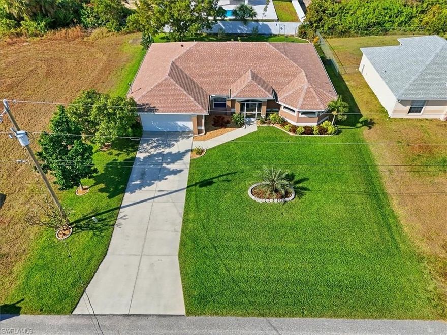 Welcome to 2512 NW 8th Pl, Cape Coral, FL 33993. Enter the double entry doors to this super clean, immaculate home located in NW Cape that is upgraded and move-in ready! Newer ROOF (March 2023), WELL (March 2024), AC (July 2019), remodeled BATHROOMS (2024). Work from home? There is space for that! Open concept floorplan and vaulted ceilings with an updated kitchen, featuring gorgeous granite counters, an undermount sink, white cabinets, stainless steel appliances, and a neutral backsplash. Don't miss the screen-enclosed front porch, large screen-enclosed lanai, and partially fenced yard. The primary bathroom is absolutely beautifully done! It features dual walk-in closets, a soaking tub, and a large "car wash" shower with a rain showerhead, all surrounded by floor-to-ceiling tile. The bedrooms feature beautiful floors, custom Florida colors, and are a great size. The interior laundry room, located off the garage, features additional storage cabinets. Don't let this one slip by! Call for a tour today!