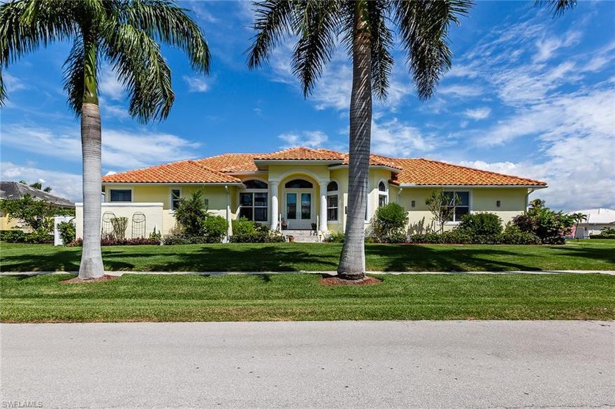 The moment you pull up to the oversized corner lot, lined with majestic Royal Palms, the beautiful sleek front stoop to the contemporary masterpiece that greets you as you pass thru the beautiful glass front doors. The grand open floor plan with fluid ease to all living areas with wall to wall windows and sliders. The kitchen is a modern marvel with ample professional grade granite countertops, lighted custom cabinets, stainless steel appliances. Large master suite with sitting area and a full wall of stacking sliders that opens grandly to the long water view. Very spacious lanai with multiple covered areas to relax & entertain. Enjoy a dip in the kidney shaped pool with fountain. Dock & lift with large dock. So many features they cannot all be listed here. Call for separate special feature sheet. PLEASE NOTE THAT THE ROOM IN THE GARAGE IS NOT PERMANENT, BUILT WITH BREAKAWAY WALLS TO CONVERT BACK TO EXTRA LONG 3RD GARAGE SPACE!