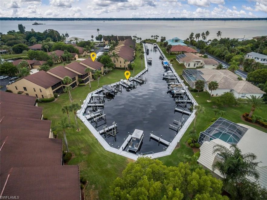 “Beach Love” is the feeling you get walking into this beautifully updated, direct Gulf access condo. Incredibly maintained, 1st. floor & end location only 20 steps to your private boat dock & 600 feet to the open water of the Caloosahatchee River.  All new kitchen that has been opened to showcase the marina & sunset views. Upgraded shaker style cabinets, granite countertops, build-in wine cooler, stainless appliances, sunny breakfast nook, whole house water filtration & 18” ceramic tile throughout the home. Charming “BEACH” decor where everything is move in ready. Master bedroom has 2 walk-in closets and sliders to the lanai. The split bedroom plan provides privacy when guest arrive.  The spacious den with a closet can provide for extra sleeping. Have your coffee with the sunrise on the front screened porch and wine with the sunset on the screened lanai.  Includes a private dock (a $15,000 value) and lift plus a very private personal spa.  Admiralty Yacht & Racquet is an active boating and tennis community on the banks of the river.  Convenient to I-75 or the activities & restaurants in the downtown, “River District”. A perfect retreat from northern winters!! Furniture negotiable.