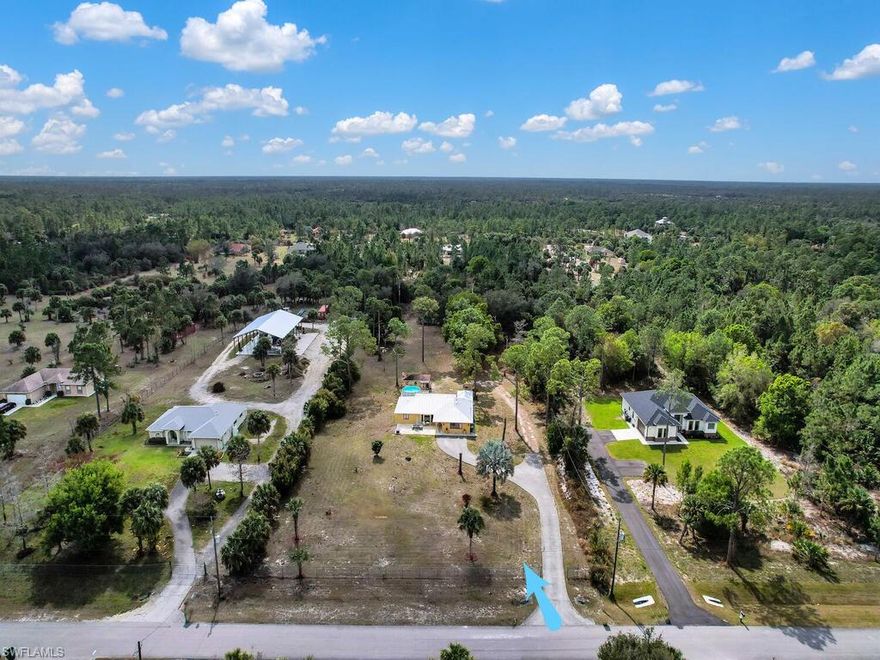 VERY COUNTRY SETTING! This single family home is situated on 2.73 acres in a non-gated neighbourhood w/ NO HOMEOWNER FEES. Offering a long drive w/ lots of parking space, plenty of room for all your toys, great room layout, updated open kitchen, cathedral ceiling, 2 master suites, huge screened rear lanai, detached garage/workshop near home, and additional out building w/ water & electric on very rear of property. Convenient location - easy access to I-75 & US 41, Ave Maria, 5th Ave Naples shopping/dining district, and the beaches that line the Gulf of Mexico. BACK ON MARKET DUE TO BUYER FINANCING