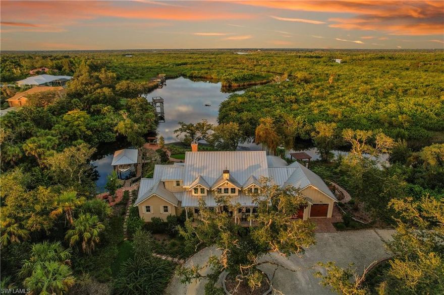 This private, gated, meticulously designed, old Florida style home, located on a 4.5 acre preserve, represents an exceptional opportunity for discerning buyers. Spanning 5,500 square feet under roof and 3,300 square feet under air, this property provides ample space for both indoor and outdoor relaxation and entertaining. The entrance foyer welcomes you with its elegant antique barn style door and vaulted ceilings, leading into a sophisticated living room adorned with natural light from skylights and 3 sets of double French doors. The soaring handmade brick gas fireplace draws you into the living room. The spacious kitchen is equipped with stainless steel appliances, an over-sized butcher block island with a sink, and a breakfast bar, ensuring a seamless flow for culinary enthusiasts and social gatherings. The dining area, featuring tasteful wainscoting, further enhances the home’s refined aesthetic.

All bedrooms feature en suite bathrooms and walk-in closets. An upstairs bedroom boasts a gorgeous HGTV inspired tailor made bunk room with two queen and two full size beds. Amongst the books in the library you'll find a customized murphy bed and in the den you'll find the tv hidden behind handcrafted wooden doors. The home also has an eye for the practical with both indoor and garage holiday storage closets. No space is left unaccounted for with wall to wall cabinets in the garage with its squeaky clean epoxy floor. The home has a generous 1,000 gallon propane tank to support the whole house generator and you can feel safe with hurricane impact windows and doors. The standing seam metal roof offers superior weather protection.

Outdoor living is at its finest with a screened in living room and outdoor kitchen, gas fireplace, and pool, all set against the backdrop of tranquil views of Deep Creek. With over 300ft feet on the waterfront, it's a short boat ride to the Peace River and then out into the Gulf. The metal roof boat house, with 10,000 lb boat lift, accommodates up to a 30 foot boat surrounded by a composite material dock with a fish cleaning table for your catch of the day.

This property not only offers luxurious amenities but also a lifestyle enriched with the proximity to local parks, recreational facilities, and waterfront activities. This residence is a must-see for those seeking stunning water views and lush landscaping in their own private oasis.