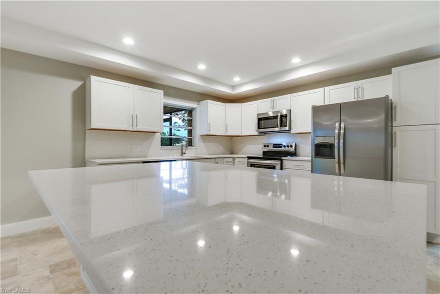 Stunning renovated home in highly sought after non-gated, deeded neighborhood of Greenwood @ Palm River! Brand New Roof!! Nestling up to a 2.5 acre preserve/park area with walking path and a community pool gives this 3 bedroom home a wonderful peaceful & serene setting. Completely remodeled with taste from ceiling to floor and wall-to-wall and featuring an open concept kitchen with movable island, quartz counter-tops and back splash & new stainless steel appliances, freshly painted inside & out, gorgeous Travertine flooring throughout, front entryway w/ Frank Lloyd Wright appeal, disappearing slider system leading from great room to lanai, tall base & custom trim on windows, new fans & light fixtures, and new landscaping. You will love the outdoor living space this home has to offer w/ new picture window screening to enjoy the beautiful view of the preserve/park area and enough room for an outdoor dining set & lounging chairs. Storm ready home w/ some impact glass windows, accordion shutters on lanai, and clear manual shutters for the rest of the home. Absolutely a rare find-"like new" home with an unbeatable setting!