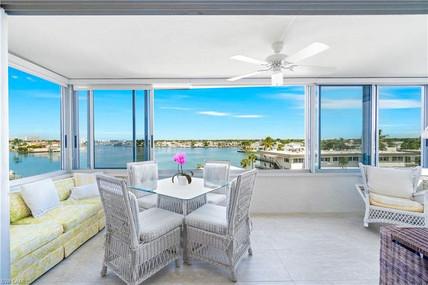 Perfectly positioned between Venetian Bay and the Gulf, this sixth-floor residence at Harborside West in The Moorings offers a peaceful retreat with tasteful finishes, featuring 3 bedrooms, 2.5 baths, and 1,702 square feet of living space. Enjoy beautiful sunrises, panoramic bay views, dolphins at play, and tranquil breezes from the spacious glass enclosed lanai with versatile sliding windows. The split-bedroom floor plan provides privacy and comfort with en-suite bathrooms and generous closets in both the primary and guest suites, while the third bedroom may also serve as an office and is conveniently located near the well-appointed half bath. The kitchen offers upgraded custom cabinetry and abundant natural light. Additional conveniences include two deeded parking spaces, one under the building, and one under the detached carport, and an extra storage closet. Harborside West provides exceptional amenities including a beautifully renovated social room with a full kitchen, fitness room, heated pool, grill area, library, hobby room, fishing pier, bike storage, and vehicle wash area, all within a friendly, secure building with on-site management. Ideally located within walking distance of Venetian Village and just across the street from beach access, residents may also join the Moorings Homeowners Association for private beach access.