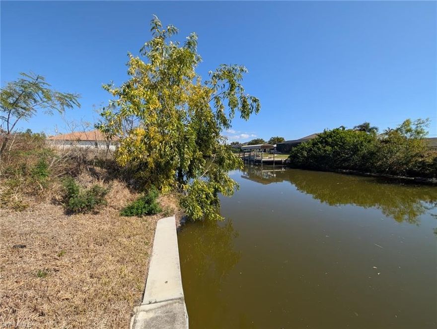 Discover the perfect location to build your dream home on this southern exposure gulf-access waterfront lot in beautiful SW Cape Coral. Situated in the highly desirable SW area of Cape Coral, this property offers stunning water views and sun throughout the day due to its southern exposure. The lot features a new seawall, saving you significant construction costs and giving you a head start on building. The lot itself is also relatively high, so not a lot of fill will be needed for construction, saving you money. This property offers easy access to shopping, dining, tons of schools within a mile, and all the amenities Southwest Florida has to offer. Whether you're planning to build now or invest for the future, this waterfront homesite is a fantastic opportunity. The assessments are nearly paid off! Don't miss your chance to own a piece of boating paradise with an amazing gulf-access canal view, southern exposure, and a new seawall already in place on this gulf access property! *The lots next door is available for sale too - Buy both and build the home of your dreams on half an acre*