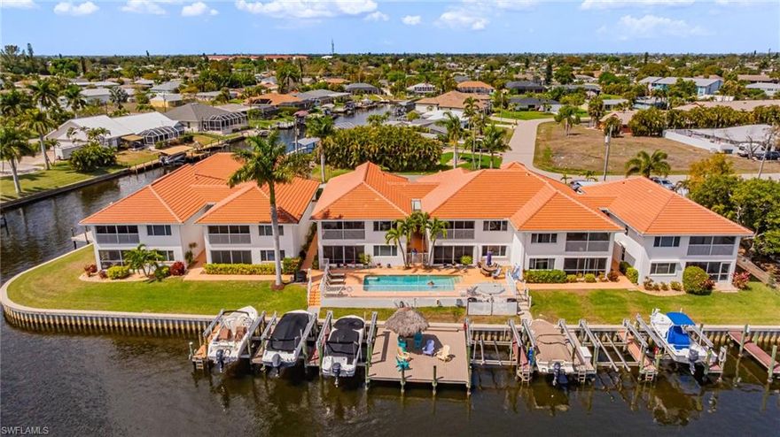 Located on the RUBICON CANAL, with Gorgeous INTERSECTING Canal views, this rarely available first-floor THREE BEDROOM, two-bath residence offers an exceptional opportunity to enjoy the best of waterfront living in Cape Coral. The property includes a DEEDED BOAT SLIP with a Remote-Controlled 10,000 lb. BOAT LIFT, providing effortless access to the water. From your dock, it’s just one bridge and approximately 13 minutes to the Caloosahatchee River. The unit itself has been meticulously cared for. All Brand-New Stainless-Steel Appliances in the kitchen, AC replaced in 2024, Hot water Heater replaced in 2023, and the Master Bath completely remodeled in 2022. There are TILE floors throughout, NO Carpet here! The Lanai has been re-screened and fitted with acrylic sliders, for maximum enjoyment year-round. Palm Vista is an exclusive, low-density community of only 14 residences, offering a relaxed and private atmosphere. Residents enjoy a community pool, spa, BBQ area, and two docks with charming tiki huts, all overlooking the expansive intersecting canals. The association is well managed and financially sound, with major improvements already completed, including new roofs (2025), a new spa (2025), and seawall replacement (2019)—all while maintaining low condominium fees. Located in FLOOD ZONE X, where flood insurance is not required, this truly unique waterfront residence offers a rare combination of location, boating access, privacy, and value—the perfect place to experience the coastal lifestyle that Cape Coral is known for.