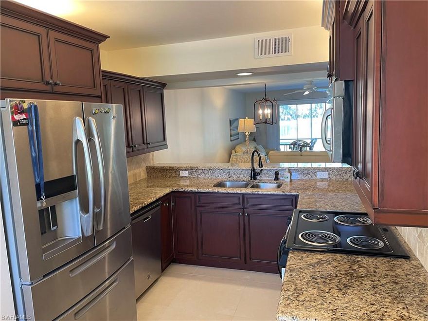 *Lowest Priced Condo In Sherwood - And It Has Been Recently Updated Too!* This Immaculate First Floor Condo Is Bright & Open, W/ Manicured Landscaping Around A Peaceful Long Lake View Featuring 2 Water Fountains. You Must See The Inside Of This Unit To Believe How Beautifully Updated It Is - Looks Brand New! 2+Den, 2 Baths, 1 Car Garage, 1225 Sq Ft Under Air, W/ A Screened & Tiled Lanai To Sit & Enjoy Paradise! Kitchen Recently Remodeled, & Features Wood Cabinets W/ Crown Trim, Granite Counters, SS Appliances, & Tumbled Stone Backsplash. Both Bathrooms Were Renovated In 2020... Master Bathroom Features New Vanity, Dual Sinks, Granite Counters, Frameless Glass Shower Door, & Walk-In Closet. 24" Tile Throughout The Condo (No Carpet!), Freshly Painted In Neutral Colors, French Glass Doors On Den Makes It Useful As 3rd Bedroom If Necessary. A/C Replaced In 2018, Plantation Shutters In Master, & All TV's Stay Hung On The Wall. Sherwood Boasts 2 Community Swimming Pools, Tennis & Pickleball Courts, & A Clubhouse W/ Exercise Room. It's Located 5 Minutes To I-75, 12 Minutes To Downtown Naples & The Beaches, & 20 Minutes To Marco Island! At This Price, This Condo Will Not Last!