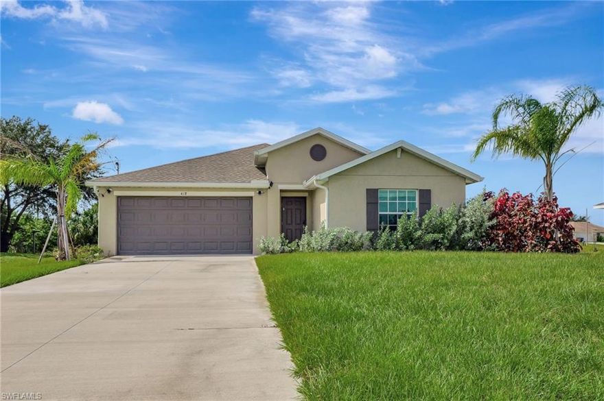 Built in 2023, this well-maintained single-story home in Lehigh Acres offers a clean, modern layout with 4 bedrooms and 2 bathrooms. The open-concept design creates a seamless flow between the kitchen, living, and dining areas, ideal for everyday living and entertaining. Tile flooring runs throughout the main living spaces for durability and easy maintenance. The kitchen features white cabinetry, quartz countertops, stainless steel appliances, and a large center island with additional seating. The split-bedroom layout provides added privacy, with a primary suite that includes a walk-in closet, dual sinks, and a walk-in shower. Secondary bedrooms are well-sized and share a full bathroom with tub/shower combination. Sliding glass doors open to a spacious backyard with room to personalize or create outdoor living space. Additional features include a 2-car garage, indoor laundry, and no HOA restrictions. Conveniently located near major roadways, shopping, dining, and daily essentials.