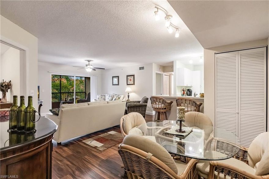 Bright & beautiful two bedroom, two bathroom top floor condo loaded with updates AND includes a rarely available CARPORT in San Mirage, a luxury gated community in the heart of Bonita Springs. Features include hand scraped-style laminate flooring, stainless appliances, upgraded kitchen cabinets, upgraded kitchen and bath fixtures, ceiling fans, newer water heater, and more. Spacious open floor plan features a great room, split bedrooms, breakfast bar, and a relaxing third-floor, treetop view of palms. A second deeded parking space is located directly in front of the building. Live in your own private oasis with lush tropical grounds that include a resort-style salt water pool and spa, clubhouse, exercise room, tennis court, Grilling area, car wash station, & more. San Mirage is a quiet, well-managed community with low HOA fees that include basic cable, water/sewer, pest control, & lawn maintenance. Desirable location, less than 5 miles to Bonita Beach, minutes from I-75, Coconut Point, The Promenade, and Miromar Outlets. This condo is move-in ready, offered partially furnished, and an absolute must-see.