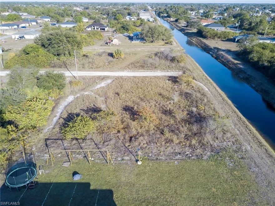 No Flood Zone No HOA. Beautiful Corner Lot on a fresh water canal with a little over 1/3 of an acre Located in Lehigh Acres most desirable neighborhoods, offering the perfect opportunity to build your dream home or investment property. The lot is ready for construction, with a flat, clear surface that makes development simple and efficient. Conveniently situated just minutes from shopping, restaurants, churches, and other local amenities, this property provides both accessibility and a peaceful residential atmosphere. Whether you’re looking to live in a thriving community or capitalize on a growing area, this lot offers a prime location for any project. 15 Miles From The RSW International Airport.