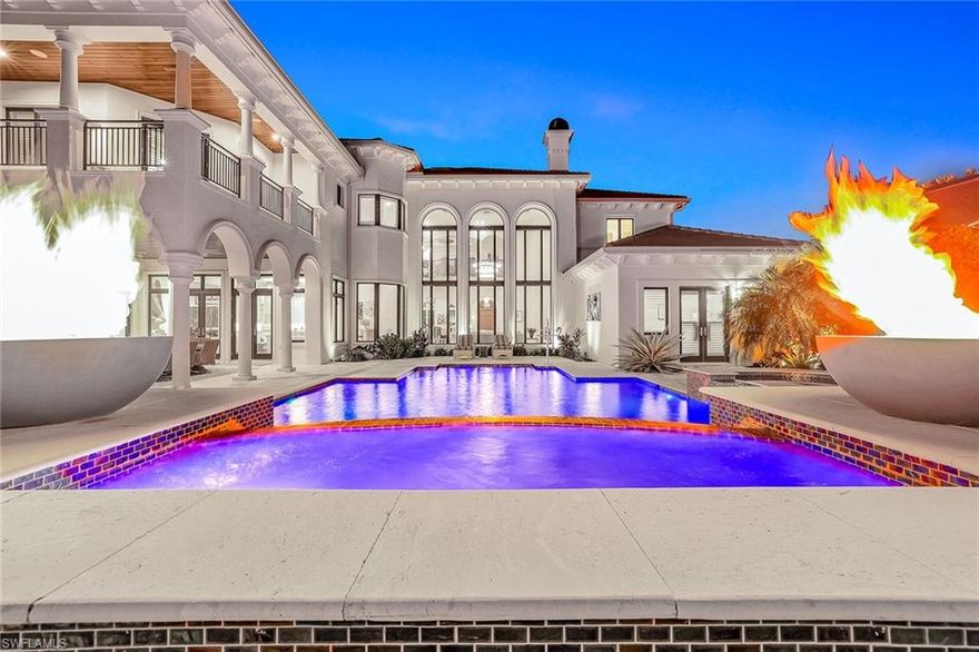 Welcome to an extraordinary opportunity to live the ultimate luxury lifestyle in Talis Park, where an exclusive full golf membership is immediately available, allowing you to skip the waitlist and begin enjoying world-class amenities from day one. Set on one of the community's most coveted lots, this unparalleled estate is ideally on a secluded 0.5-acre, south-facing cul-de-sac lot. The residence is a masterpiece of design and sophistication, offering an expansive floor plan with two lavish primary suites and four additional bedroom suites, each with a beautifully remodeled ensuite bath. A private casita provides an ideal, independent retreat for guests. Convenience and peace of mind are paramount, with an in-home elevator for easy access to all levels and impact glass windows and doors for ultimate protection. For the car enthusiast, the air-conditioned five-car garage offers abundant space for vehicles and storage. Go outside into your private oasis, where breathtaking views of the pristine 15th hole and a sparkling lake create a serene backdrop. This outdoor sanctuary is an entertainer's dream, complete with a fully equipped outdoor kitchen, a stunning saltwater pool and spa, a cozy gas fire pit and dramatic fire bowls. Inside, the home is appointed with extraordinary features, including electric and gas fireplaces, a bar lounge with a backlit quartz bar, a wine dispenser and a stunning 1,100-bottle temperature-controlled wine room. A recent 2023 roof adds a layer of security and value to this exceptional property. Talis Park offers a refined, active lifestyle with a spectacular 18-hole Pete Dye-designed golf course and an array of amenities including pickleball, tennis, bocce, multiple dining options, a state-of-the-art fitness center, and a luxurious spa. You'll also find scenic trails for recreation and a dog park. This ideal location places you just minutes from pristine beaches, fine dining, upscale shopping and RSW International Airport. This one-of-a-kind estate leaves nothing to be desired, offering a unique and refined living experience. Outstanding value, priced under appraised value, so don't miss your opportunity to own this remarkable residence.