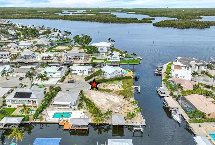 This extremely rare and unique property featuring 0ver 100 feet (combined with lot 18 is over 200 feet) of water line on a quiet cul-de-sac with gorgeous bay views is now within your reach. Purchase separately or as a package of 2 properties with lot 18 next to it, to build your waterfront island home (or two if you wish) on these oversized canal lots with combined size of .37 acres and easy beach access right around the corner. Lot 18 has boat lift with dock and a grandfathered boat house with metal roof while the open air boat lift has a secondary spot for jet skis as well as a boat. 20 has a separate boat lift with dock. 20 also has a view of the back bay. The possibilities are endless here, only your imagination is needed.
