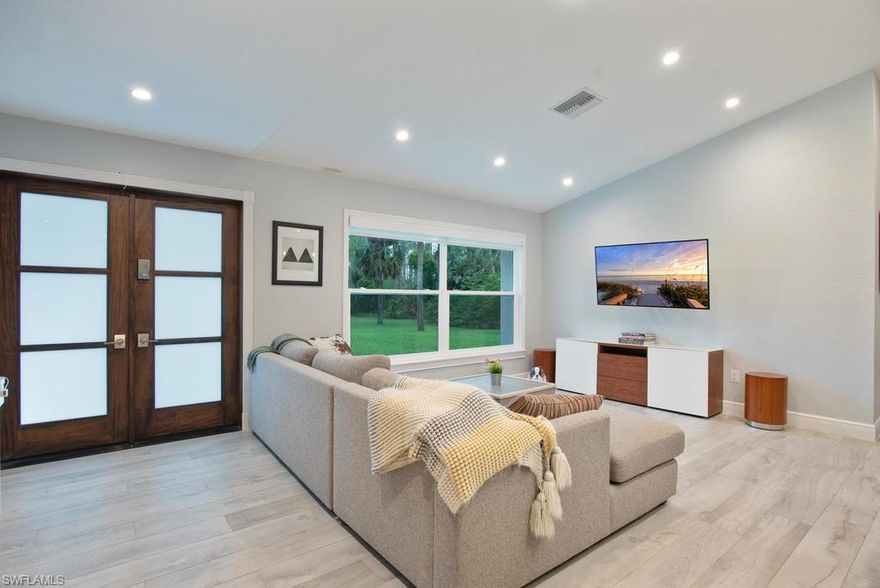 Stunning and spacious, with peaceful surroundings, and "close in" convenience.  Nestled on 2.5 acres, west of Collier Blvd., this beautifully updated home will thrill those looking for both a modern aesthetic, and tons of character.  Barn doors, shaker cabinets, quartz counters, and wide open concept floor plan, all designed with a cool gray/blue color palette, will make it easy to fall in love with this beautiful home.  The gorgeous island kitchen will surely be "the hub" of the house, and delight the chef of the family.  An abundance of windows (with electric shades), and four sets of French doors, flood the interior of the home with natural light. Outdoor entertaining will be a pleasure with this beautiful pool and lanai.  This highly desirable home will sell very quickly.  Schedule your showing today.