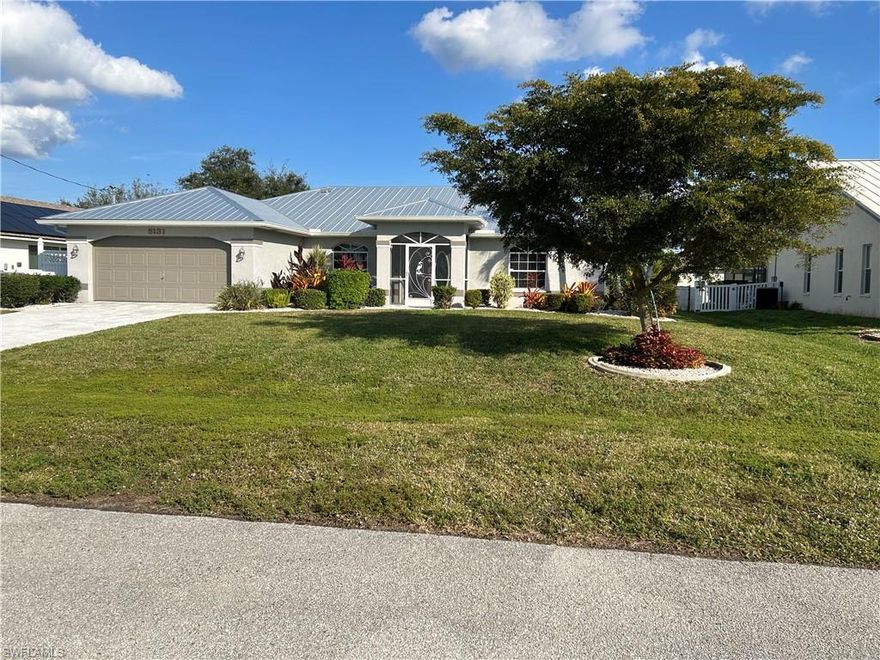 LOCATION, LOCATION, LOCATION, If you want an affordable house in a quiet neighborhood and a five minute walk to Camelot Park where you can enjoy lighted pickleball & tennis courts, horseshoe pits, playground for children ages 2-12, walking track, and picnic shelters with grilling facilities, this is the home for you.  There is a Publix Grocery, Walgreens and Cape Harbour are a 3 minute drive (or you can walk). There is abundant natural light and the open vaulted ceiling makes this home feel even more open and welcoming.  There are three bedroom, plus a den with French doors. This house has been well maintained including the  2017 A/C unit being serviced professionally twice a year.  The new steel roof is from 2023.  The UEP is fully paid.  The electrical 200 amp panel was replaced in 2016.  All appliances including washer and dryer are included.  The flooring is all tile and laminate throughout the house.  There is an inground irrigation system. The 8x10 shed will provide ample storage for garden supplies and  toys. The  fully fenced back yard provides security and privacy  and is large enough to add a pool if you would want to do so.  The landscaping adds so much interest to this home and adds to that feeling of privacy. New garage door opener 11/25. The house is fully equipped for hurricane protection and there is a current wind mitigation (done 2023) that will help with insurance.  There has never been any water intrusion into the home. If you want a home that you can move into and enjoy right away, please check this home out.