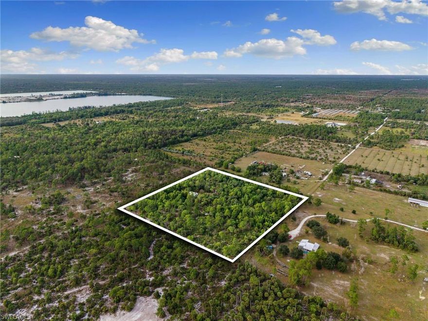 Nestled at 630 Pioneer Trail, this exceptional 10-acre square parcel offers three distinct pathways to prosperity on 100% buildable uplands with residential and agricultural zoning. Strategic investors will appreciate the subdivision potential of this well-proportioned lot, complete with infrastructure already in place including 200-amp service, new power poles, transformer, fresh cable lines, a deep freshwater well, and family-sized septic with paid impact fees. Family estate builders can envision their legacy unfolding across partially cleared land with established perimeter and cross-fencing, where over 30 peacocks roam and a manufactured home already graces the property, all set on superior perc sand soil with limestone base and rock-free to eight feet. Diverse plant life including bamboo trees, lemon grass etc. Business owners will find immediate opportunity with the agricultural zoning, existing structures, robust electrical capacity and versatile layout perfect for landscaping operations, nurseries, or agricultural ventures. The convenient dirt access road maintains rural character while proximity to I-75, Collier Boulevard, and downtown Naples keeps you connected to Southwest Florida's beaches and amenities, making this rare offering ideal whether you're holding for future appreciation, building your family compound, or launching your commercial dream today.