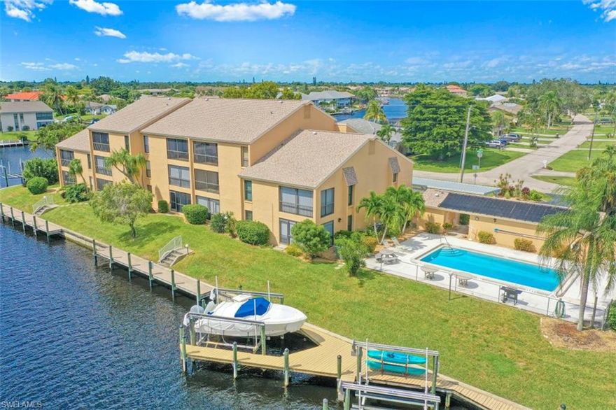 Affordable GULF ACCESS FIRST FLOOR condo on the corner of the Rubicon and Plato canals. This wonderful community has a beautiful composite board captains walk dock.  Water is abundant and if you have a boat, Enjoy fabulous intersecting canal views from your lanai ... park your boat in your back yard & head to the Gulf of Mexico any time you care to with a STRAIGHT SHOT to the river with only one bridge. Or if you prefer just fish & enjoy the wildlife outside your own back door. A few doors away you can enjoy the glorious Florida sunshine poolside. This well maintained condo has NEW IMPACT WINDOWS, NEW A/C, and NEW HOT WATER HEATER. Great floor plan and inside laundry - many cabinets in kitchen with NEWER stainless steel appliances - dining room area opens to living room that has a wall of sliders overlooking canal.  You'll enjoy the southern exposure while relaxing on the SCREENED LANAI that joins the master bedroom or soak in the Large SOLAR HEATED POOL offering pool bathrooms w/ storage.  Great location with quick access to shopping, dining, & more. Dock access is deeded to HOA  Don't miss out on this one!
