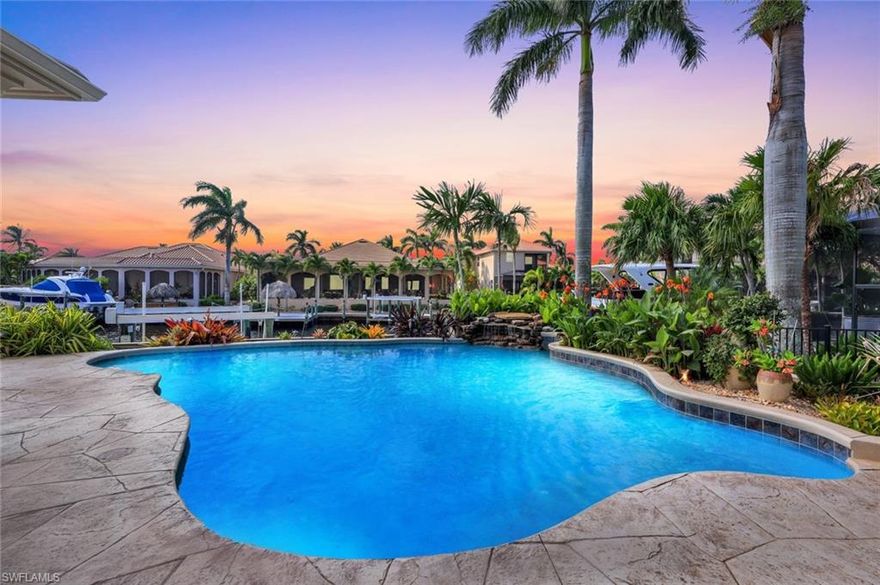 Luxury waterfront living awaits in Cape Harbour—a yachting community that offers an unparalleled lifestyle. The new tile roof is just a glimpse of the home's exceptional features. Bathed in southern sunlight, numerous sliding glass doors open to a heated waterfall pool and patio area. The kitchen is equipped with stainless steel appliances, a center island, gas range, double ovens, a sub-zero refrigerator, and a walk-in pantry. The home is designed for comfort with expansive open spaces for entertaining, a cozy gas fireplace, and a large family room. The primary suite serves as a private retreat, featuring a sitting area, a luxurious bath with custom closets, dual sinks, a soaking tub, and a rain shower. Spacious guest bedrooms include Jack and Jill baths and an additional half bath for guests. The property also offers a workroom/exercise room & full den/office. Outside, the heated waterfall pool is perfect for relaxation, enhanced by a summer kitchen with a beverage refrigerator, all overlooking the wide waterfront canal. An oversized, elevated sideload garage provides ample storage for outdoor gear, and a central vacuum system adds convenience. There are two AC's systems. The lush, tropical landscaping includes majestic palms, a sprinkler system, and shade trees. Boating amenities include an electric 20,000-pound lift and dockside water/electric with unobstructed access to the Caloosahatchee River and the Gulf of Mexico. The Cape Harbour community features shopping, health facilities, tennis, pickleball, and exceptional waterfront dining. This home is ready for you to start living the dream of a luxurious waterfront pool home.