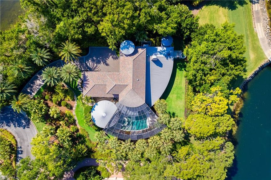 Introducing a masterpiece of architectural ingenuity harmonizing seamlessly with the splendor of its natural surroundings. This ‘radial designed home’ features a 180-degree curved veranda, embracing panoramic vistas of the Pine golf course fairway, serene lake, majestic pines, and stunning landscaping. Inside, an open floor plan fosters fluidity and expansive space allowing you to optimize the use of space to suit various lifestyle preferences.  The home boasts just over 5000 sq ft, with 3 bedrooms plus den with elevator. A cozy library provides a serene retreat for book enthusiasts, while a flexible space offers boundless opportunities for customization and personalization, whether as a home office, fitness area, or creative studio.The main living area gracefully transitions into a generously proportioned lanai, featuring a gorgeous pool and spa. Discover a secluded retreat, featuring a private covered area adorned with a tranquil fountain and inviting sitting area.  The property boasts a detached guest house, elegantly designed in a circular style, resembling a charming casita.Grey Oaks community offers premier recreational facilities, including a sprawling 30,000 square foot wellness center, three world-class golf courses, tennis and pickleball courts, bocce, two clubhouses, and a resort-style pool. Beyond its exceptional amenities, Grey Oaks boasts a reputation for unparalleled service, delivering a first-class living experience.