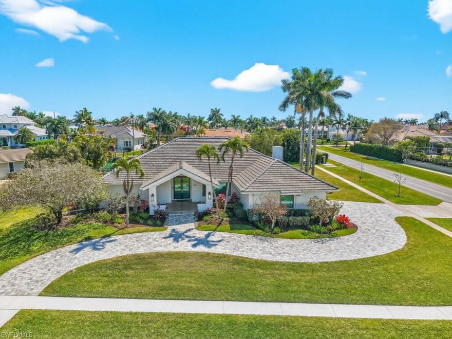 This exquisite residence, fully renovated in 2022, offers direct water access, popular southern exposure for all-day sunshine at the pool & outdoor living areas & a beautiful coastal furniture package. Perfectly positioned on an oversized half-acre corner lot in the prestigious Estates of Marco, the property boasts approximately 160' of seawall & direct Gulf access by boat with no bridges. The home showcases custom white cabinetry, custom closets & shades, all-new tile flooring throughout, new plumbing & lighting fixtures, plus fresh interior & exterior paint.  Designed with a light & airy coastal aesthetic, the open-concept floor plan features a large living area with a vaulted ceiling, double kitchen islands with lots of cabinetry storage space, 4 bedrooms & 3 beautifully updated baths.  Impact glass doors & windows provide peace of mind & abundant natural light.  The expansive south-facing lanai is ideal for entertaining, complete with roll-down screens & a spacious saltwater pool & spa. Relax in the shade or soak up the Florida sun while enjoying tranquil canal & long waterway views.  Boaters will appreciate the new dock & lifts, including 20,000# & 10,000# lifts (dual jet ski platform).  Additional highlights include a new tile roof (2024), new pool equipment (2023), a climate-controlled 3-car garage with a mini-split system, a new paver driveway & walkway leading to the dock. Move right in and start living the island dream!