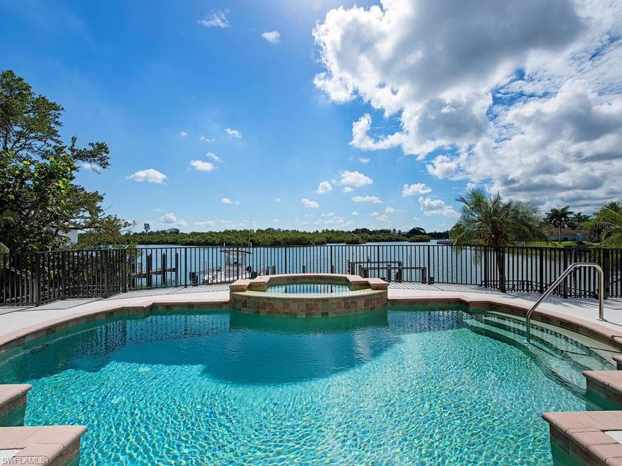 H.14590 -Enjoy the easy lifestyle of this home with awe-inspiring views overlooking the wide waters of Champney Bay, and in the distance a protected Mangrove Preserve! French doors across the rear of the home  open out onto the large lanai with sunny pool and spa providing heavenly views from the kitchen, dining area and great room as well as the spacious master bedroom!  The open floor plan and built-in bar make entertaining a breeze! There is also a study on the first floor, and upstairs there are two lovely, large guest bedrooms with en-suite baths. Two boat docks with lifts will accommodate all your water toys, with direct Gulf access out Gordon Pass just a couple minutes away! Walk across the street and right onto the beach via the private beach access deeded to this property, making this a rare opportunity, indeed! This is a very livable property as it is, but the true value is in the land with its exceptional views and location, location, location! Would be an easy rental property or interim home while designing your dream home! The coveted Gordon Drive Beach Estates address gives the owner eligibility for an Associate Membership in the Port Royal Club. Floor plan attached.