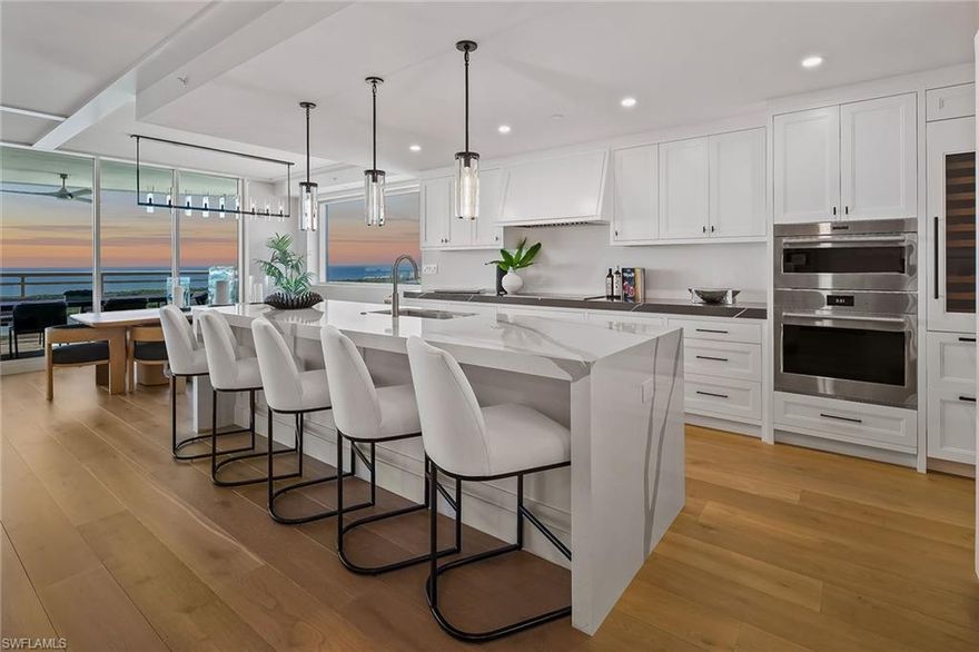 Wake up to breathtaking Gulf and bay views from this stunning, pet-friendly 3,722-square-foot, 22nd-floor luxury residence in Tower 300 at Kalea Bay, one of Naples, Florida’s prestigious resort communities. This newer-construction, furnished residence offers an exceptional coastal lifestyle with three bedrooms plus a den (optional fourth bedroom), three-and-a-half baths, and refined interiors by RH design. The open-concept living space flows seamlessly to a west-facing wraparound terrace with glass railings, showcasing panoramic sunsets, Gulf and Intracoastal boating views, sugar-white beaches, the sparkling skyline of North Naples, and golf views of Kinsale Golf Club just across the street. The chef's kitchen features Wolf and Sub-Zero appliances, quartz countertops, oversized island, wine cooler, refrigerator and freezer drawers, and a butler’s pantry. The primary suite is a private retreat with water views, spa-style bath, dual vanities, soaking tub, walk-in shower, bidet and a generous built-in closet. All bedrooms are en-suite with built-in closets, and the main living area features pocketing impact doors that open directly to the water views. Additional highlights include a large laundry room with built-in office, hardwood floors and custom millwork throughout, soaring ceilings, designer lighting, impact-resistant glass, solid-wood doors, private elevator entry and accordion storm shutters on the lanai. Residents enjoy five-star tower amenities including rooftop pool and barbecue, fitness center, party room and catering kitchen, along with full membership at The Club at Kalea Bay, featuring three resort-style pools, two poolside tiki huts, two on-site restaurants, a $14 million state-of-the-art fitness and wellness center, tennis, pickleball, bocce, 12 exclusive guest cottages, dog park, beauty salon, kayak and paddleboard launch, business center, kids and teens centers, and a vibrant calendar of social events. The optional Beach Club offers indoor and outdoor beachfront dining, along with full chair, umbrella, towel, and food-and-beverage service on the beach. Guard-gated with 24/7 security and two assigned garage spaces on upper lobby level, this residence represents the pinnacle of luxury coastal living in Naples.