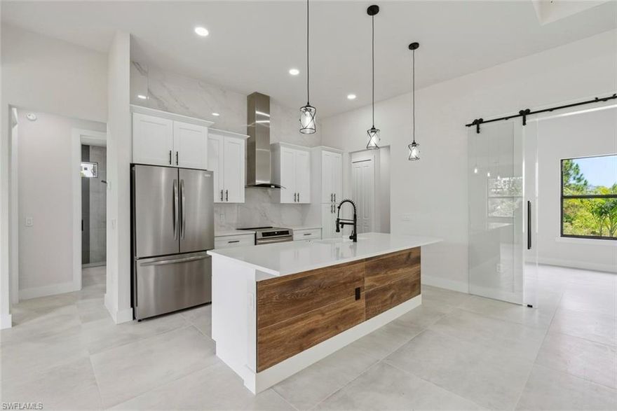 HALF ACRE!!! HOUSE WITHIN A MONTH OF CERTIFICATE OF OCCUPANCY. Sod is in! Appliances are in! Summer kitchen a week before completion in August. This is your dream home - imagine the possibilities! 2024 construction. No HOA! Spartan Model 1. HALF ACRE (.50), room for your custom pool/screened lanai. WE ARE APPROACHING THE  FINISH LINE!  Don't miss your opportunity - 4 bedrooms or office with a glass barn door, 3 full baths (one bath dual purpose designed as a pool bath when you are ready!) and a 2-car garage. Doors and windows hurricane rated impact glass. Primary room light and bright with French doors out to lanai and two extra windows. Stainless appliances and range hood. Estimated move-in August 2024. This luxury, contemporary style home is like no other. Signature style of this builder and the attention to detail is unique in this open floor design. Home includes 32x32 tile throughout, gutters, automated irrigation, exquisite fixture finishes, 12' ceilings in living room and 9'4" throughout home, 8' doors, utility room w/sink, pantry, mud room, breakfast bar/island, deep kitchen sink, tray ceilings. Extraordinary fan and light package adding to the luxurious look. Beautiful tile flooring. Big back yard. Call today for your personal tour.