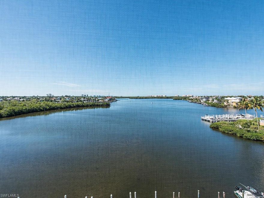 WIDE BAY VIEWS FROM EVERY ROOM! From the moment you step foot in the door, all you can see is the beautiful waters of Hickory Bay. Southern exposure from the spacious 5th floor lanai, which is the full width of the condo and accessible from all rooms. This split bedroom floor plan has been completely and exquisitely updated with wood cabinets and granite counters in kitchen and both baths, tile backsplash, stainless steel appliances, beautifully updated showers with frameless glass and turnkey furnished! Porcelain tile floors throughout the living area, and the gorgeous bamboo flooring in the bedrooms add to the tasteful tropical décor. Brand new air conditioner last year and electric hurricane shutters on the lanai. Direct gulf access via the first-come, first-serve boat slips. Great location for kayaking, canoeing or paddle boarding and walking distance to Barefoot and Bonita Beaches! Under the building parking space and private storage space too. This is the one you've been waiting for!