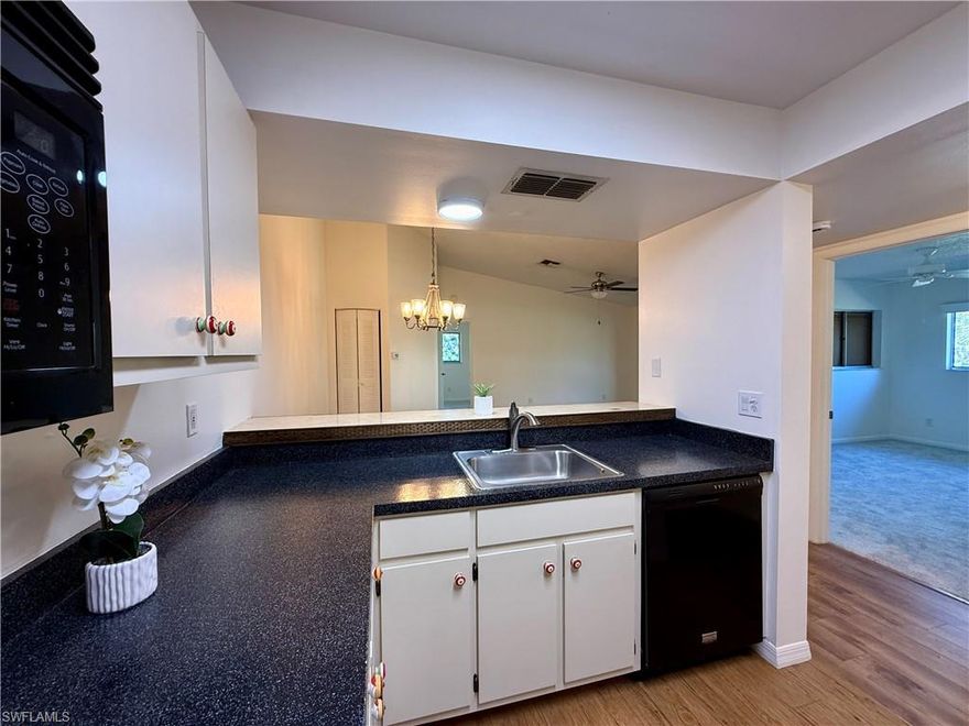 Discover this affordable gem in a gated community featuring a community pool and tennis courts. Ideally located across from Lakes Park, with a scenic pathway open from dawn to dusk, perfect for walking, jogging, or cycling. Enjoy the nearby Botanical Gardens and a weekly Wednesday Farmers Market for fresh produce and local goods.

This condo offers recent updates, including new carpet in the bedrooms and living room, along with new LVT flooring throughout for a modern touch. Water, cable, and building insurance are included in the low monthly condo fees. Built in 1991, the unit benefits from a new AC system replaced in 2017. The lanai features glass and screen panels, providing added comfort and versatility. Both bedrooms boast spacious walk-in closets.

Don't miss out on this fantastic opportunity!