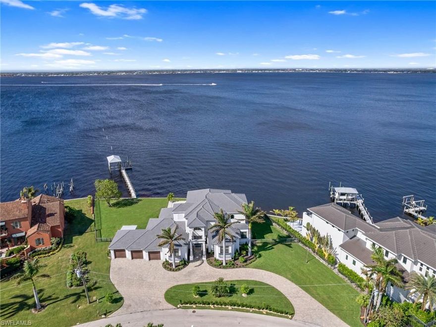 Live the riverfront lifestyle you’ve been dreaming of at 951 Aqua Lane, where modern design meets breathtaking natural beauty. Nestled on over half an acre with 180+/- feet of direct water frontage, this 2013 custom-built home combines elegance, functionality, and panoramic sunset views. Designed for seamless living, the home offers over 4150 sqft under air, soaring ceilings and recessed lighting throughout. The open-concept layout features a chef’s kitchen with a generous breakfast bar and formal dining space. Four ensuite bedrooms include a private Top Floor VIP suite with a morning kitchen, sitting area, lavish bath area, dual extra large walk-in closets, a private office, and a spiral staircase leading directly to the pool deck. The outdoor spaces are made for entertaining, with a resort-style pool, relaxing spa, and an outdoor kitchen complete with a built-in grill and dining area. You will enjoy a fantastic dock with a covered boat lift provides convenient access out to the gulf and bay waters for boating enthusiasts, while the spacious oversized yard adds room for activities and relaxation for the family and pets. With a three-car garage, newer codes quality construction, high elevation for protection and unparalleled attention to detail, this home is more than a residence—it’s your personal oasis that's located in a fantastic area of SWFL. Schedule your private tour today!