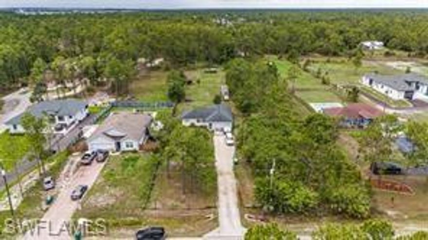 Charming Country Retreat on 1.4 Acres in Golden Gate Estates Welcome to this peaceful and well-maintained three-bedroom, two-bathroom home nestled on 1.4 acres in the desirable Golden Gate Estates. Offering over 1,300 square feet of living space, this residence provides a serene escape with no HOA restrictions. Enjoy tranquil views from both the rear lanai and front porch. The kitchen features warm wood countertops, while the master bedroom is appointed with wood laminate flooring and a spacious walk-in closet. Additional features include manual hurricane protection and a fully fenced yard—ideal for pets, privacy, or gardening. Situated on a quiet road, this property is just a short drive from shopping centers, parks, and public golf courses. This is the perfect opportunity for first-time homebuyers or anyone seeking outdoor space and freedom from HOA fees. Schedule your private showing today—this home won’t disappoint!