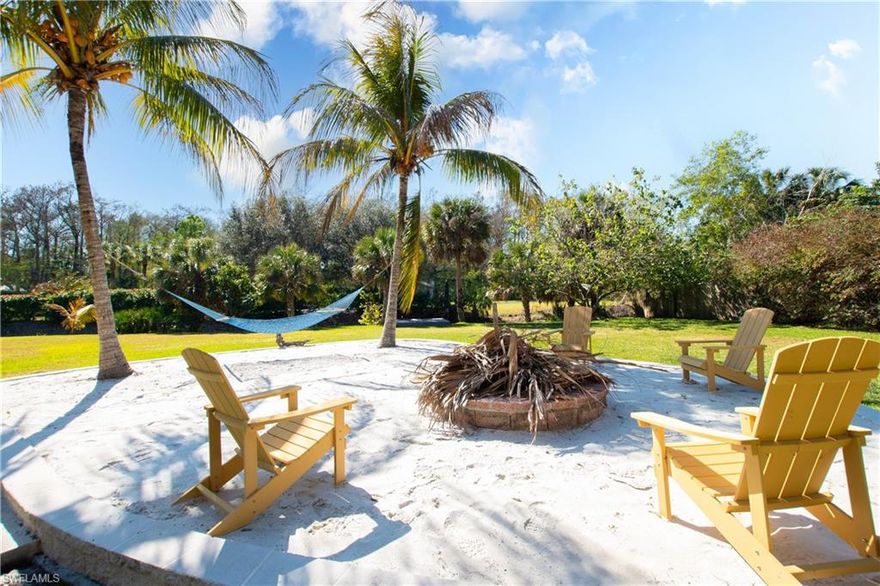 Experience Florida in a truly unique custom-built home, unlike anything else available on the market today. If you’re looking for a dignified appreciation for classic Florida architecture and a lush native landscaped yard where you can spend peaceful weekends outdoors, this home delivers! Set back from the road, the crushed shell driveway leads you through a tunnel of greenery and opens to pure Old Florida charm. The home stands out  with a Key West inspired yellow Hardie Board siding and a wide screened porch. The timeless layout offers individual curated spaces, to be tailored for the way you live your life. On the first floor, you’ll find the primary suite with an open bathroom and walk-in closet with custom shelving. The staircase is front and center, a focal point, separating the formal living space from the family room. The kitchen is bright and inviting, with an abundance of storage found in exquisite German Alderwood cabinetry. From the breakfast nook, step out onto a covered screened porch overlooking the beautiful backyard. Upstairs, you’ll find a loft space, with 3 separate air conditioned bonus rooms, 2 generously sized guest bedrooms and a full bath. The attic (3rd floor) was converted to enclosed air-conditioned storage as well. Custom designed and meticulously maintained for 29 years by the same owners, this home tells a story of craftsmanship and love. Constructed with both solid poured concrete and 2x6 framing with conventional rafters built on site, not factory-built trusses. New metal roof in 2025 and two AC units both replaced in 2020. What the home offers inside is not to be overlooked by the details outside; 2.5 manicured acres with a mix of native Florida foliage and fruit trees. Walk the shell path through the shaded Cypress head to the backyard complete with your own private sand beach, a huge grass area, covered gazebo and a lighted fishing dock over the canal. Automatic lighting at dusk throughout the yard and landscape lighting brings an added layer of beauty, even in the dark. There’s even a parking area and RV hook up and fish prep station. All of this wrapped into an ideal location that’s close in, but feels like a private oasis.