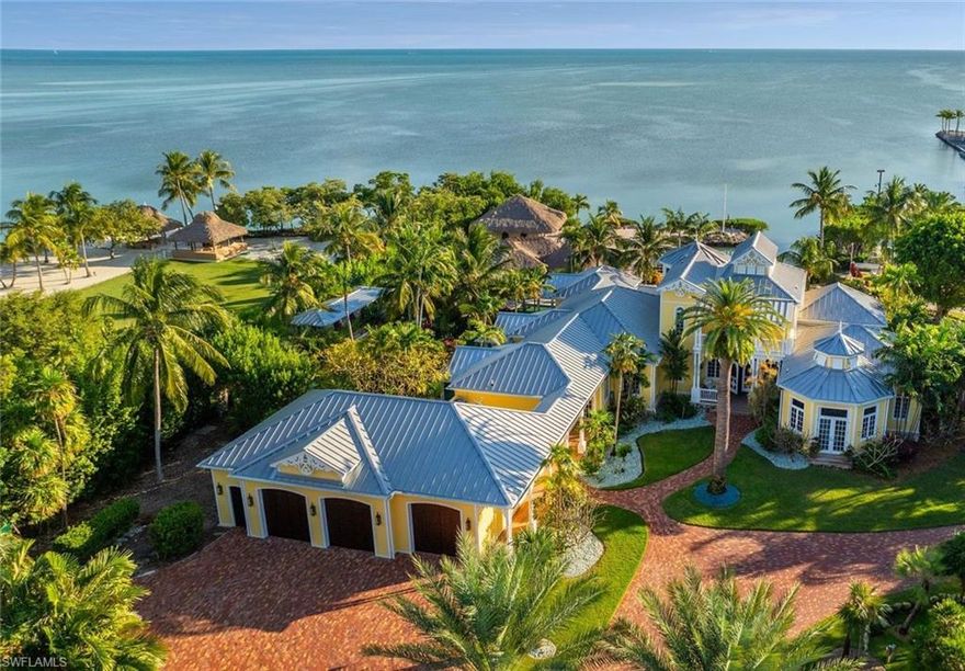 Immerse yourself in a tropical paradise where luxury knows no bounds. This breathtaking five-acre oceanfront estate, with 244 feet of private ocean frontage, is the crown jewel of the Florida Keys. From the moment you pass through the gates, you'll be captivated by a world of elegance, privacy, and unparalleled amenities. At the heart of this premier estate lies a resort-style pool oasis, complete with waterfalls, a waterslide, and a Tahitian-style river with private bedroom balconies offering entrance to the pool and leading to a swim-up tiki bar—perfect for lavish entertaining or tranquil escapes. The custom-designed 5,600+/- square foot main residence by D'Asign Source showcases exquisite craftsmanship and architectural brilliance. A separate 2,999 sq.ft. guest house offers a private retreat with its own kitchen, multiple bathrooms, and spacious living areas, ideal for hosting guests or staff. A private marina and boat ramp provide direct access to the world-famous waters of the Keys, with the bait shack nestled alongside for all things fishing and boating. Inside, every corner of this estate is designed to impress. A gourmet kitchen, opulent guest suites with private balconies offering entrance to the the lush poolscape, and a luxurious movie theater ensure every moment here is extraordinary. The primary en-suite dazzles with a stunning bathroom offering a retreat style sanctuary. Beyond the elegance, the estate is built with durability and functionality in mind, featuring impact-resistant windows and doors, generator, and cistern. Outside, explore expansive porches, a rain forest and fruit orchard, multiple garages, a carriage house, a tortoise habitat and even the potential for a private hangar. This estate isn't just a home; it's a lifestyle—your personal resort blending tropical serenity, architectural excellence, and unmatched prestige. Discover the ultimate in coastal living, where every day feels like an extraordinary getaway.