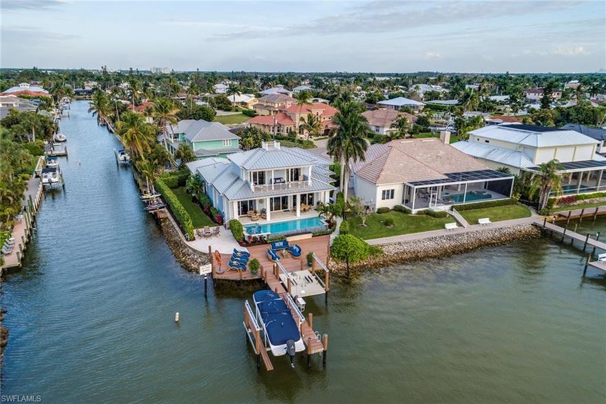 Enter into 1505 Dolphin Lane and experience unparalleled views of Naples Bay that grace nearly every room. This custom-designed home is situated on an oversized cul-de-sac lot with both Bay and canal frontage. This water lover's dream home includes two boat lifts along the Bay side as well as two jet ski lifts and a kayak launch fronting on the canal. Among the many architectural features are volume ceilings, designer wall treatments, extra wide baseboards, and tailored built-ins. Entertaining is a pleasure in this chef's kitchen featuring an oversized island, walk-in pantry and top of the line Thermador appliances. This bright, sunlit open floor plan offers five en suite bedrooms plus two half baths and a full exercise room. If you are not completely mesmerized by the spectacular sunsets over the bay, the built-in "living reef" will totally captivate you! The first floor master bedroom suite is appointed with the highest quality finishes. This Bayfront home is a car collector's dream. It offers a 3-car garage with a customized lift system designed to accommodate six cars. This sale also includes a boat and jet ski's.