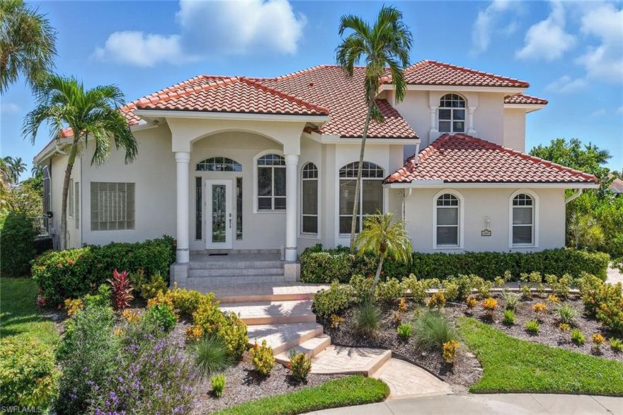 This beautifully redecorated, turnkey-furnished waterfront residence offers southern exposure, Gulf access, high income-producing potential, a huge pool/spa, high elevation and an exceptional Marco Island location close to Resident's Beach. Perfectly positioned on an oversized cul-de-sac lot with 141 feet of water frontage, this key lot provides breathtaking converging waterway views and the added privacy of a double-wide canal. Designed for both relaxation and entertaining, the home blends updated finishes, expansive outdoor living, and a light-filled floor plan with four bedrooms, three baths, a two-car garage and two stories of comfortable coastal living. The exterior has been freshly painted and enhanced with updated landscaping, creating a welcoming arrival. A private dock with lift provides quick Gulf access, while the screened lanai offers a covered outdoor living area with a ceiling fan, canal views and a heated pool and spa with a waterfall feature. The pool system has been thoughtfully upgraded with a newer heater and pump, renewed jets, a replaced glass window in the waterfall and a Hayward automated operation for effortless control. Additional outdoor features include an outdoor shower and spiral staircase connecting to the second floor. Inside, the bright and airy interior showcases volume ceilings, large windows, tile flooring in the main living areas, recessed LED lighting and upgraded ceiling fans. The remodeled kitchen is a true highlight, featuring white cabinetry with in-cabinet lighting, custom wine shelving, granite counters, a mosaic tile backsplash, bar seating, a pantry, and stainless steel appliances including a cooktop, built-in microwave, wall oven, dishwasher, and a refrigerator with an icemaker. An adjacent dining area with arched windows sets the stage for memorable gatherings. The living room offers lanai access through multiple sliders with transom windows above, a built-in entertainment center and tranquil canal and pool views. A separate great room also opens to the lanai, extending the indoor-outdoor flow. The owner's suite is a private retreat with lanai access, water views, wood-look laminate flooring, a walk-in closet and a spa-like bath with dual vanities, a soaking tub, and a glass-enclosed walk-in shower. A guest suite with laminate flooring includes an en-suite bath that doubles as a pool bath, complete with a walk-in shower and built-in bench. Upstairs, new carpeting complements two guest bedrooms connected by a Jack-and-Jill bath with a walk-in shower. A spacious loft/media room overlooks the main living areas and offers direct access to the lanai below via spiral staircase. Additional conveniences include a tiled garage with storage cabinetry, central vacuum, a freshly painted interior, custom window coverings, remodeled bedrooms to accommodate king-sized beds, and a newer HVAC unit. Just minutes from Marco Island's beaches, dining, shopping, and golf, this home offers the best of coastal living.