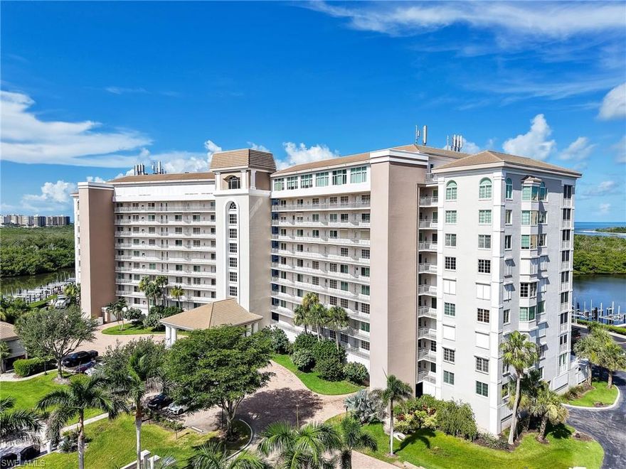 Perched majestically on the ninth floor of the prestigious Marina Bay Club, this extraordinary two-bedroom, two-bathroom condominium presents an unrivaled symphony of coastal elegance and Gulf-front grandeur. Spanning 1,390 square feet of thoughtfully designed living space, this residence transforms everyday moments into extraordinary experiences through floor-to-ceiling windows that frame breathtaking panoramas of Barefoot Beach, Vanderbilt Beach, Wiggins Pass, and the endless azure expanse of the Gulf of Mexico. The open-concept floor plan orchestrates a seamless flow of natural light and refreshing Gulf breezes, creating an atmosphere where luxury meets livability. The kitchen's sophisticated design seamlessly integrates with the living areas, perfect for both intimate gatherings and grand entertaining. Two generously proportioned bedrooms are strategically positioned for optimal privacy, with the primary suite serving as a true sanctuary featuring a walk-in closet, dual vanity, and elegantly tiled shower. Step onto your private lanai and witness nature's nightly masterpiece as spectacular sunsets paint the sky in brilliant hues over the Gulf waters. The convenience of an in-unit laundry room with washer and dryer ensures effortless coastal living. Marina Bay Club's exceptional amenities elevate the lifestyle experience with a barbecue fire pit pavilion, pickleball and tennis courts, sparkling swimming pool, elegant club room, and kayak launch facilities. The adjacent Pelican Isle Yacht Club and Cocohatchee River Park provide additional recreational opportunities, while pristine beaches lie just moments away. Nearby Mercato offers world-class shopping and dining, completing this perfect coastal paradise where luxury meets affordability in Southwest Florida's most coveted location.